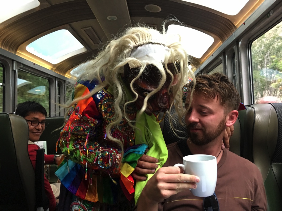 A peruvian masked dancer on the train to Machu Picchu, and me looking unimpressed with tea.